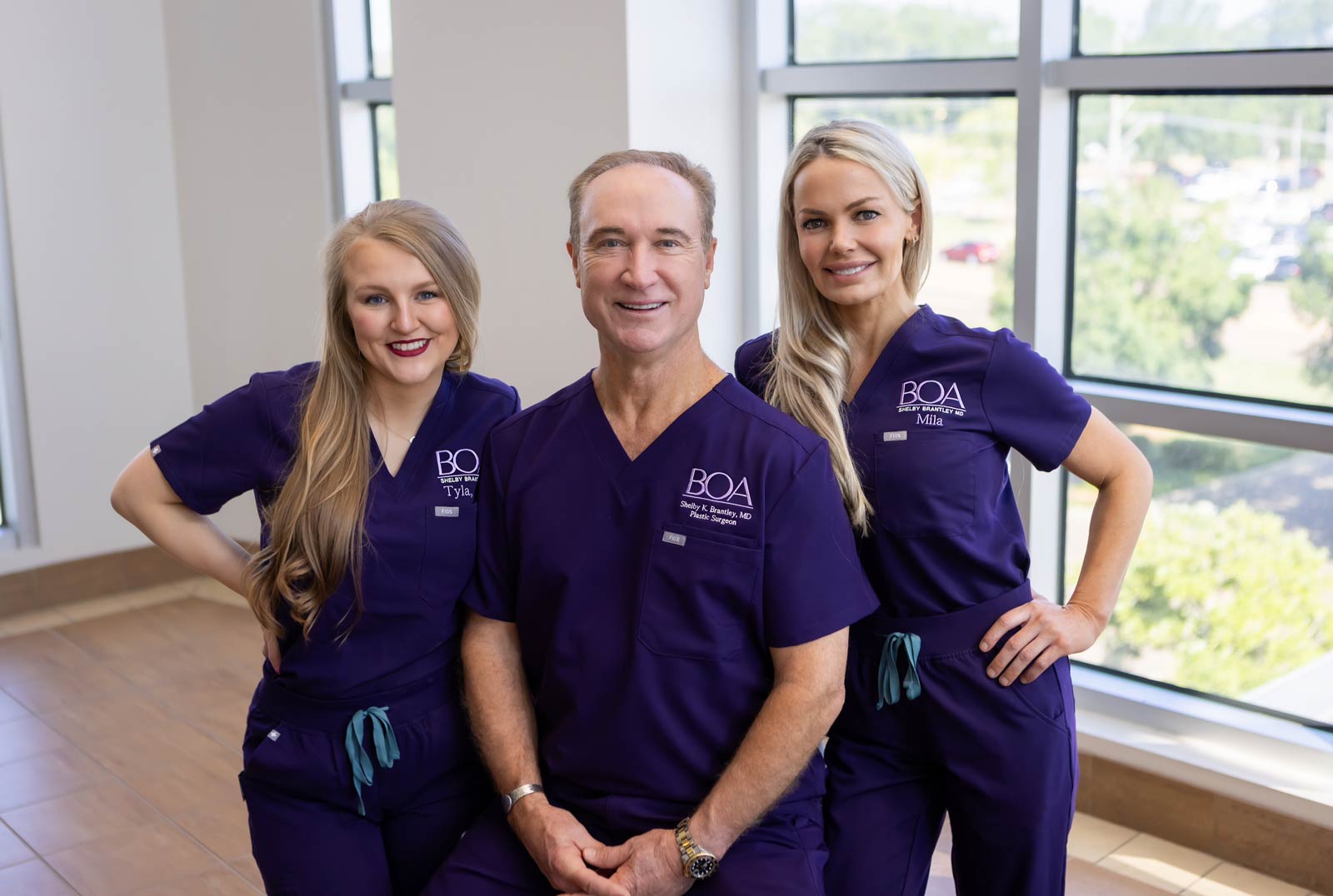 Dr. Shelby K. Brantley, Jr. of BOA Plastic Surgery and his team in purple scrubs